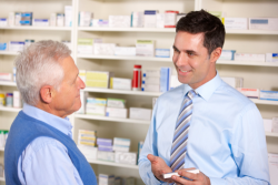 pharmacist serving the elderly person in pharmacy